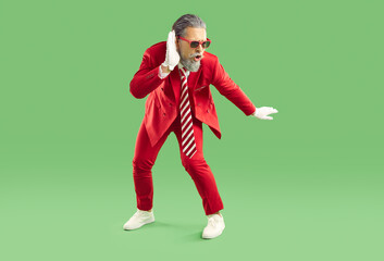 Happy man in funky trendy outfit having fun at Christmas or New Year party. Funny bearded guy in...