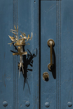 old door with cross and withered posy