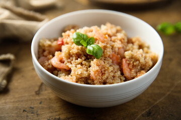 Healthy quinoa bowl with shrimps and basil
