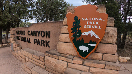 Grand Canyon National Park entrance sign nearby the South Entrance Station in northern Arizona, USA. The Grand Canyon is a steep-sided canyon carved by the Colorado River.