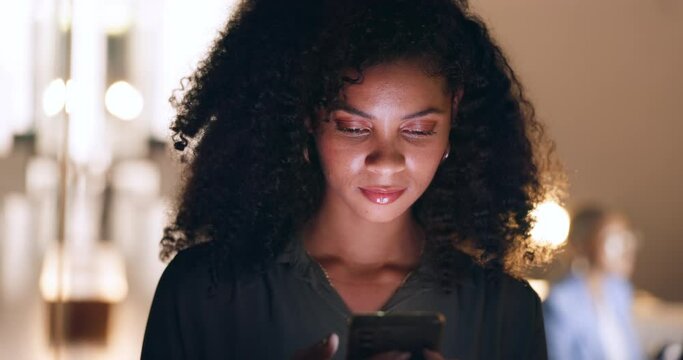 Social media, phone and black woman in a dark office for a corporate deadline at night. African worker, manager or employee typing on a mobile app with a smartphone while working overtime at work