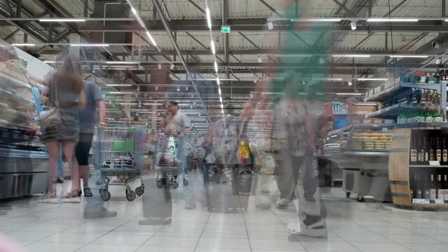 Timelapse grocery supermarket. Crowd of buyers people with shopping carts in large distribution network. 