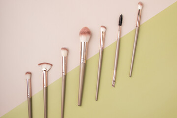 makeup brushes, Set of professional decorative cosmetics, beauty accessories on a beige background