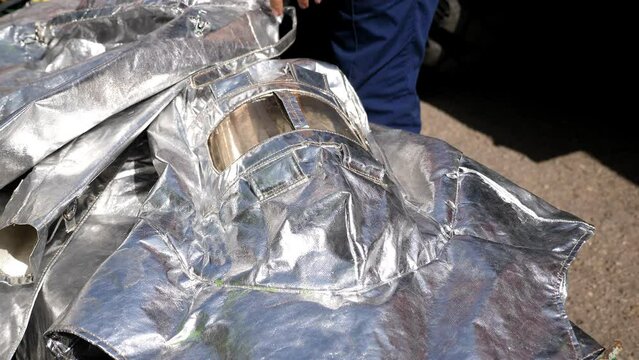 Close-up of a special protective fireproof suit made of metal foil in a fire station.