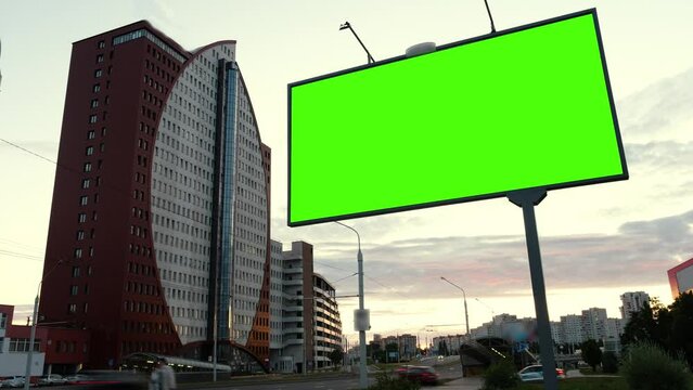 Mock up concept. Timelapse of green screen billboard on the the highway against the background of the evening sky. High quality 4k footage