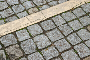 Abstract background of cobblestone pavement. Granite cobblestoned pavement background. Stone pavement