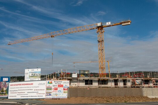 Scenic view of a yellow crane working in a construction zone