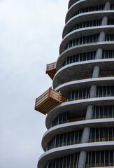 Construction of  modern skyscraper building with luxury apartments against sky. Residential development.