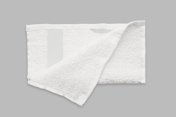 Blank white cotton bath towel with empty label mockup isolated on background. 3d rendering.