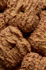 close-up of brown milk biscuits, macro view of textured snack, full frame food background
