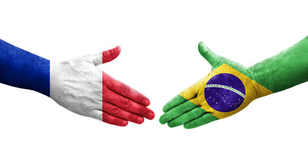 Handshake between Brazil and France flags painted on hands, isolated transparent image.