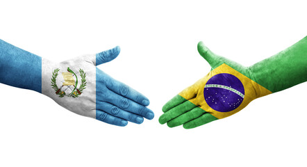 Handshake between Brazil and Guatemala flags painted on hands, isolated transparent image.
