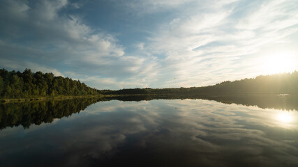 float over the lake and are reflected in the water.