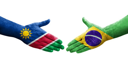 Handshake between Brazil and Namibia flags painted on hands, isolated transparent image.