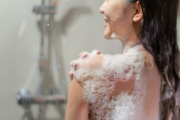 Woman bathing and washing her hair relaxed..