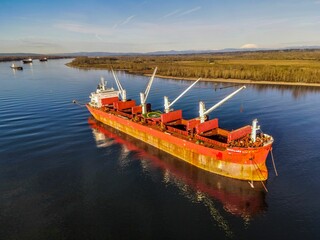Aerial shot cargo ship floating on the Columbia river near Portland during the daytime