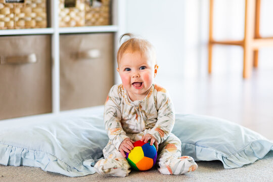 Happy Five Month Old Baby Learning To Sit Playing With Ball