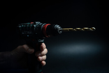 Close up of drill bit drilling into wood. Joinery and construction work close up. Wood chippings...