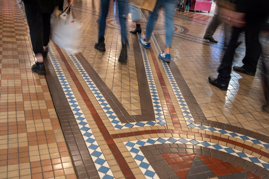 Shoppers Walking On Tiled Floor