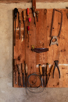 old tools hanging on wooden board