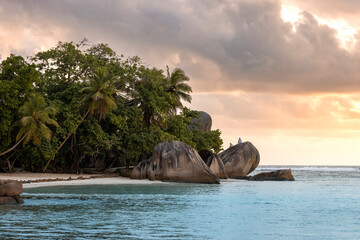 erial view from drone of a man  kayaking the floating transparent kayak on the crystal clear beach at sunset