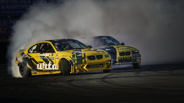 11-05-2022 Riga, Latvia A Couple Of Cars That Are In The Dirt, Two Cars That Are Racing On A Track.