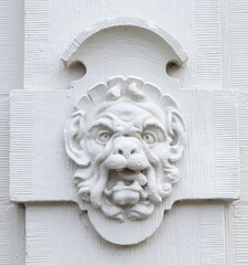 White Sculpted Gargoyle Head on the Facade of a Historic Keizersgracht Canal Building in Amsterdam, Netherlands