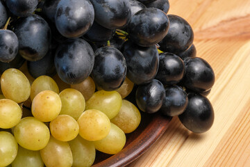 Sweet ripe white and black unwashed grapes