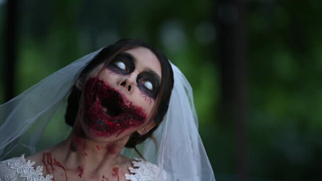 Portrait of asian woman make up ghost face with blood,Horror scene,Scary background,Halloween festival concept,Bride zombie 