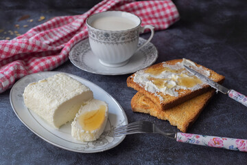 Clotted cream (butter cream) for Turkish breakfast - Kaymak, honey and glass of milk