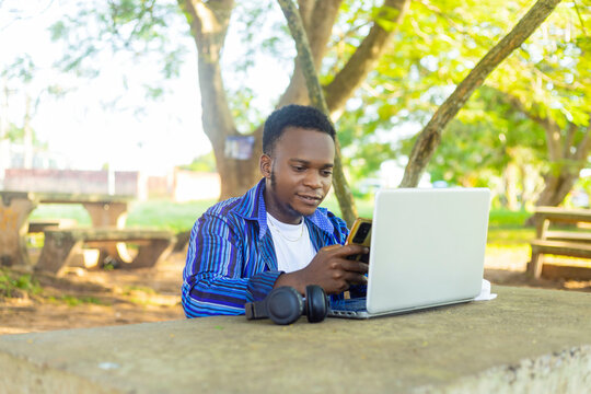 copy space image of a black african male student studying online with a mobile phone