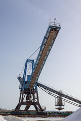 Fototapeta na wymiar Sea salt mining crane for harvesting and Salt extraction in Torrevieja, Spain