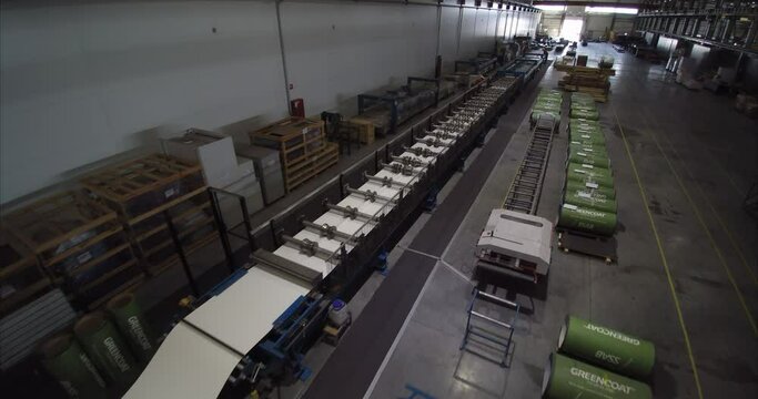 Metal sheet profile forming machine, process of making steel tile for roof. Ukraine, Kyiv - January 2021