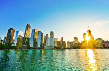 View of Chicago skyline from the shore of Lake Michigan at sunset.