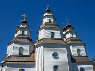 Fototapeta na wymiar Unique wooden St. Trinity Cathedral in Novomoskovsk town, Ukraine.
