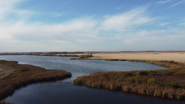 Intact wetlands in a rural area of Saskatchewan, Canada, surround by farmed fields. Late fall. 