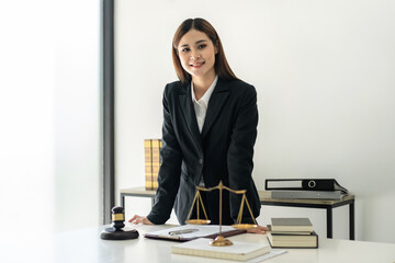 Business lawyer woman working the legal field on the table with brass scales and justice hammer...