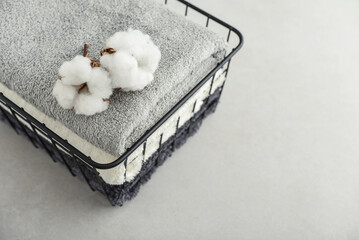  towels with cotton flowers in black metal basket