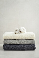Stack of bath towels with cotton flowers