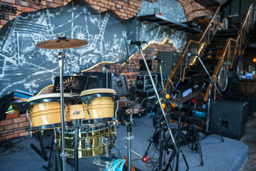 Obraz na płótnie Canvas drum kit with microphone and electric instruments in restaurant