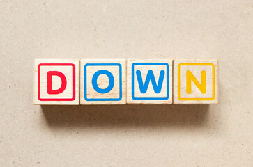 Color letter block in word down on wood background