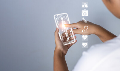 Female doctor's hand pokes at a medical icon harogram. medical concepts, treatment, medical technology, medical application