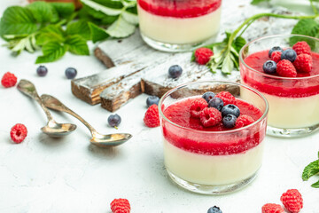 Raspberry sorbet with whipped cream and mint. Italian dessert on a light background in small jars. Long banner format. place for text