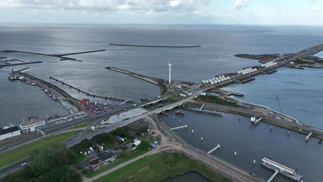 Afsluitdijk construction on pumping stations new sluices and the A7 near Den Oever, Kornwerderzand , and Zurich. Lock for shipping, road traffic cyclists and walkers. Aerial drone view.