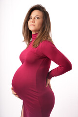 Confident beautiful middle aged 30s-40s pregnant woman touching her belly