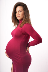 Beautiful middle aged 30s-40s pregnant woman touching her belly, thinking