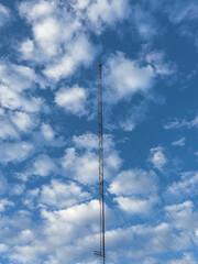 Telecommunications tower view with the background of the sky and clouds