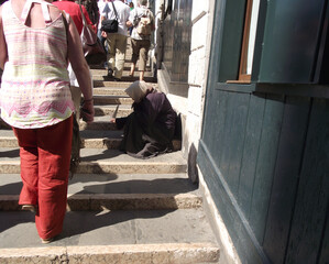 Old woman begging on the Rialto Bridge