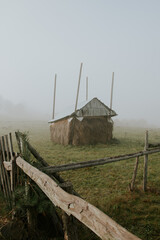 haystack in foggy field at dawn