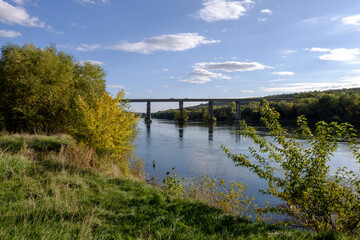 Fototapeta na wymiar the old bridge over the river landscape in autumn